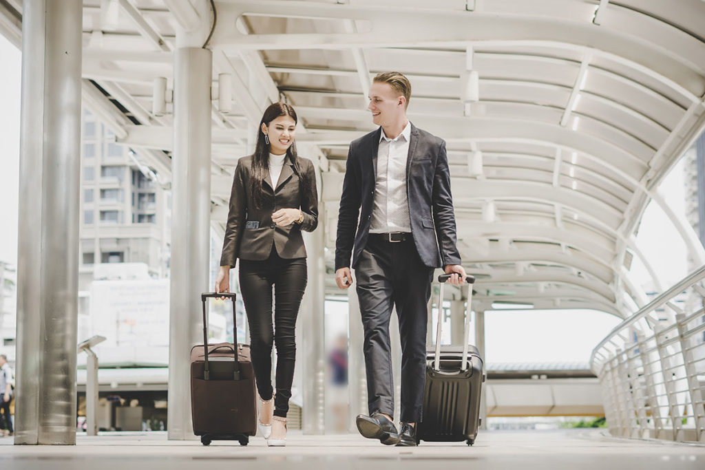 Businesswoman and businessman travelling.